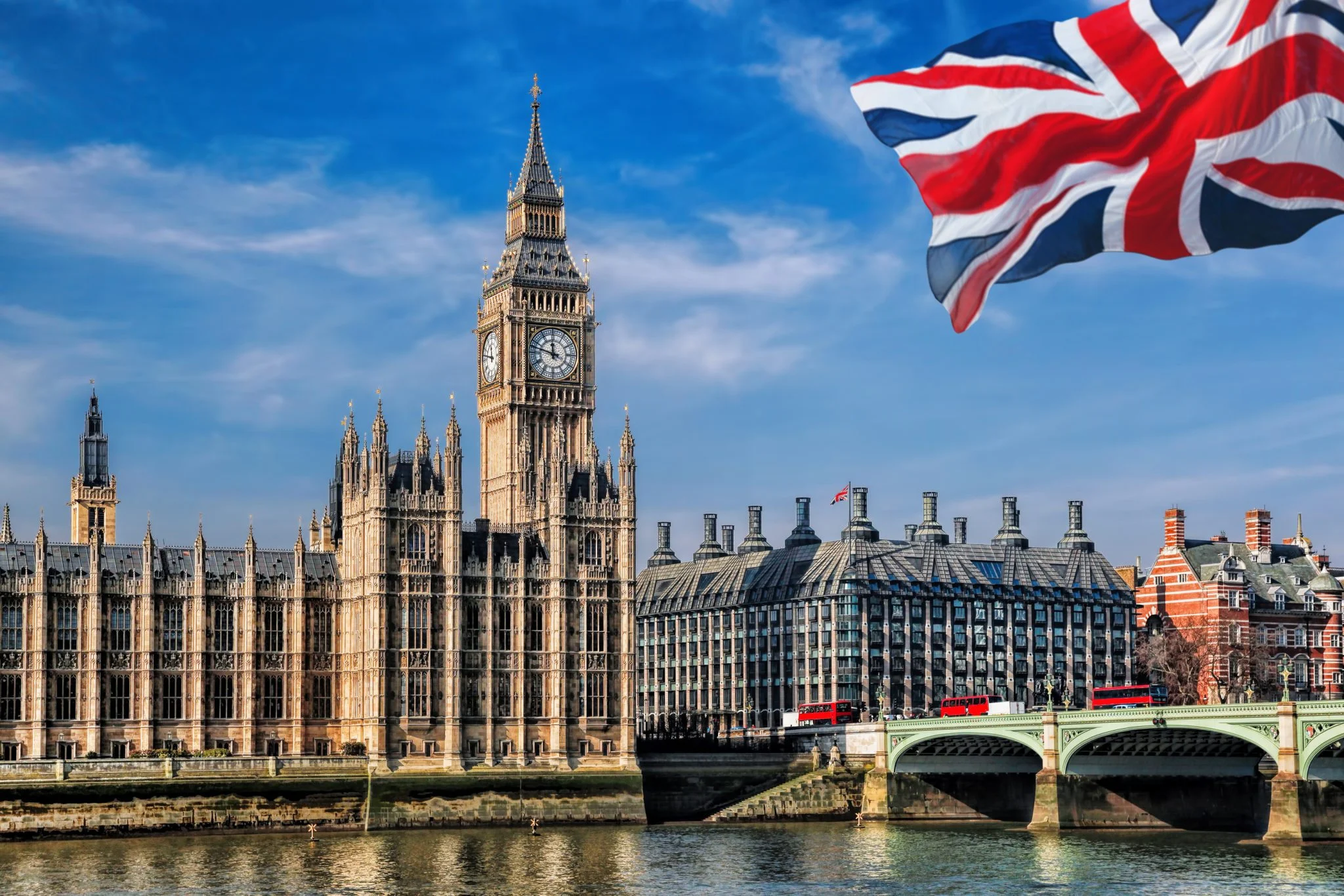 cityscape of london in united kingdom, big ben and the UK flag are visible