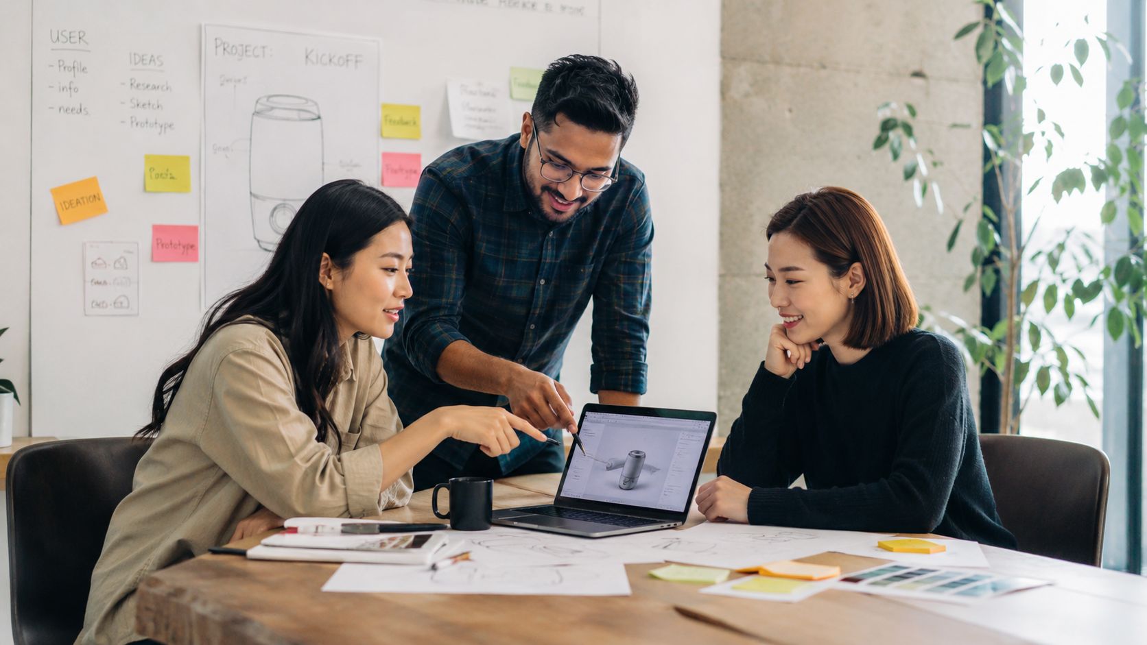 A diverse team of professionals collaborate on a product design project around a table in an office.